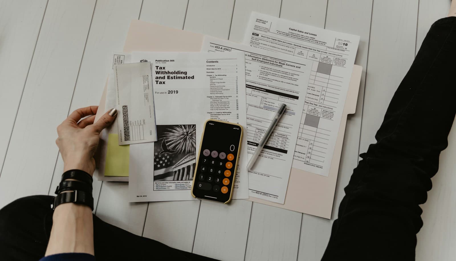 Financial documents and a calculator on a desk
